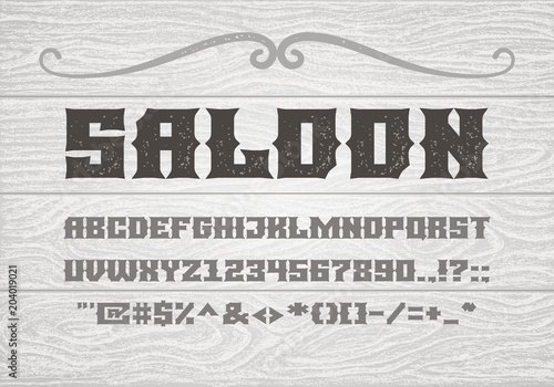 Decorative vintage bold serif font on the background of old white wooden planks