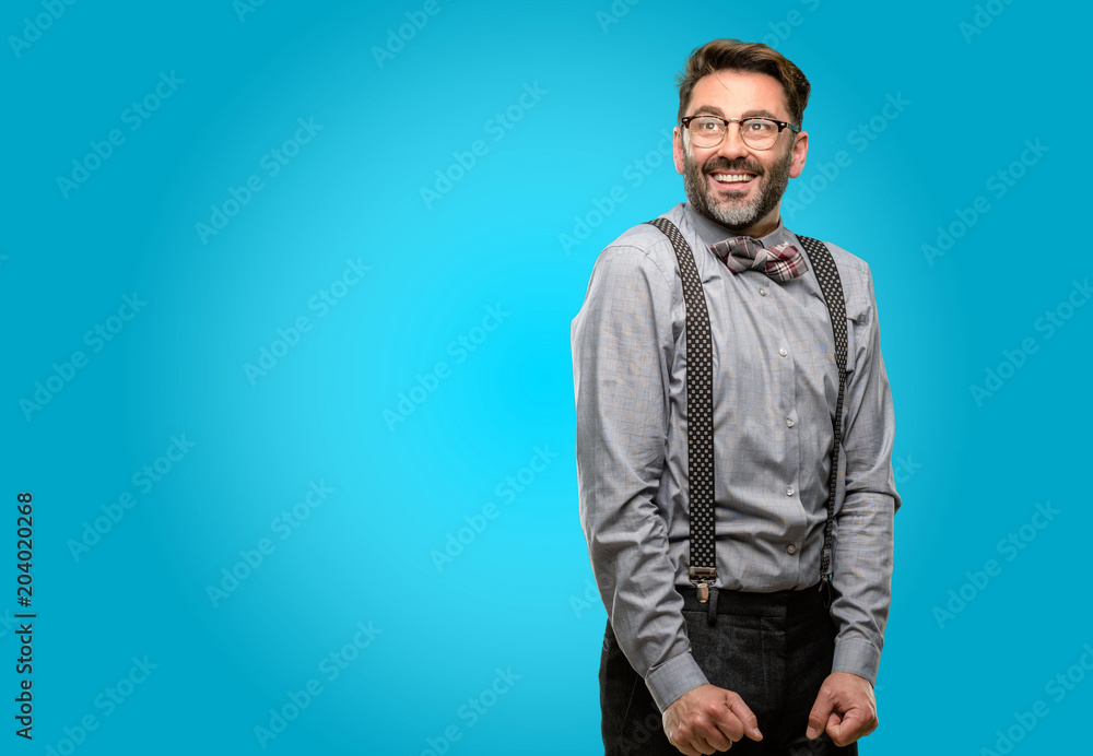 Middle age man, with beard and bow tie confident and happy with a big natural smile laughing looking up