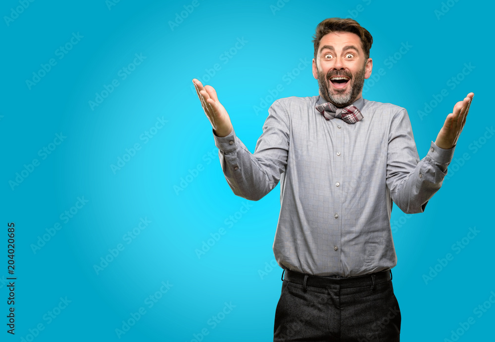 Middle age man, with beard and bow tie confident and happy with a big natural smile welcome gesture Middle age man, with beard and bow tie confident and happy with a big natural smile welcome gesture