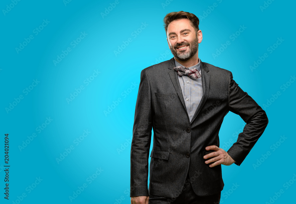 Middle age man, with beard and bow tie confident and happy with a big natural smile laughing Middle age man, with beard and bow tie confident and happy with a big natural smile laughing