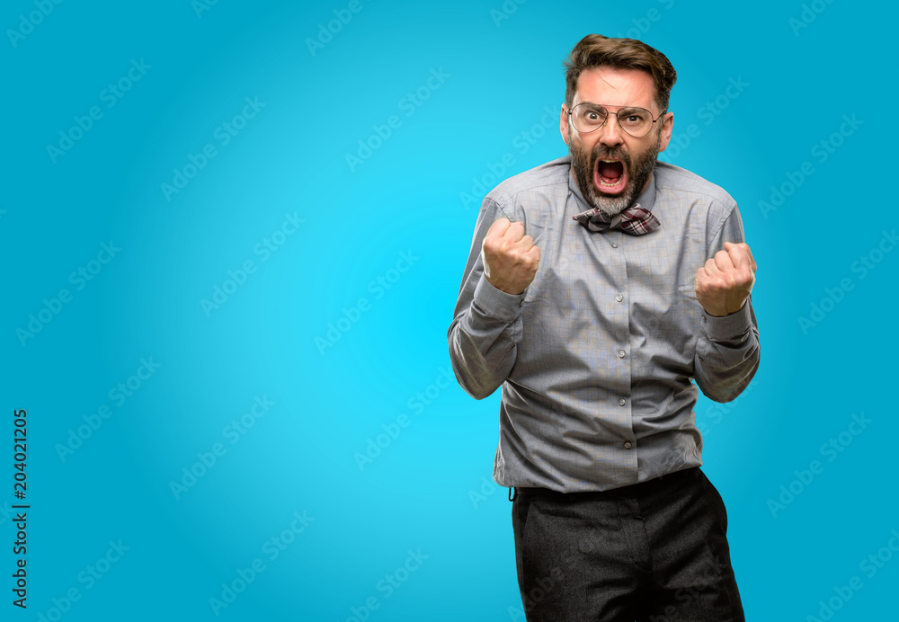 Middle age man, with beard and bow tie happy and excited celebrating victory expressing big success, power, energy and positive emotions. Celebrates new job joyful Middle age man, with beard and bow tie happy and excited celebrating victory expressing big success, power, energy and positive emotions. Celebrates new job joyful