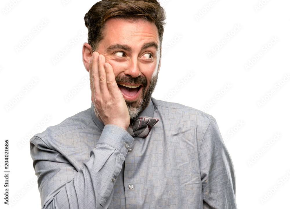 Middle age man, with beard and bow tie so happy and confident showing a big smile surprised finger isolated over white background Middle age man, with beard and bow tie so happy and confident showing a big smile surprised finger isolated over white background