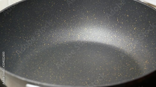 Pour the food palm oil into the black teflon induction pan. and wait for boiled in high temperature  before cooking food menu