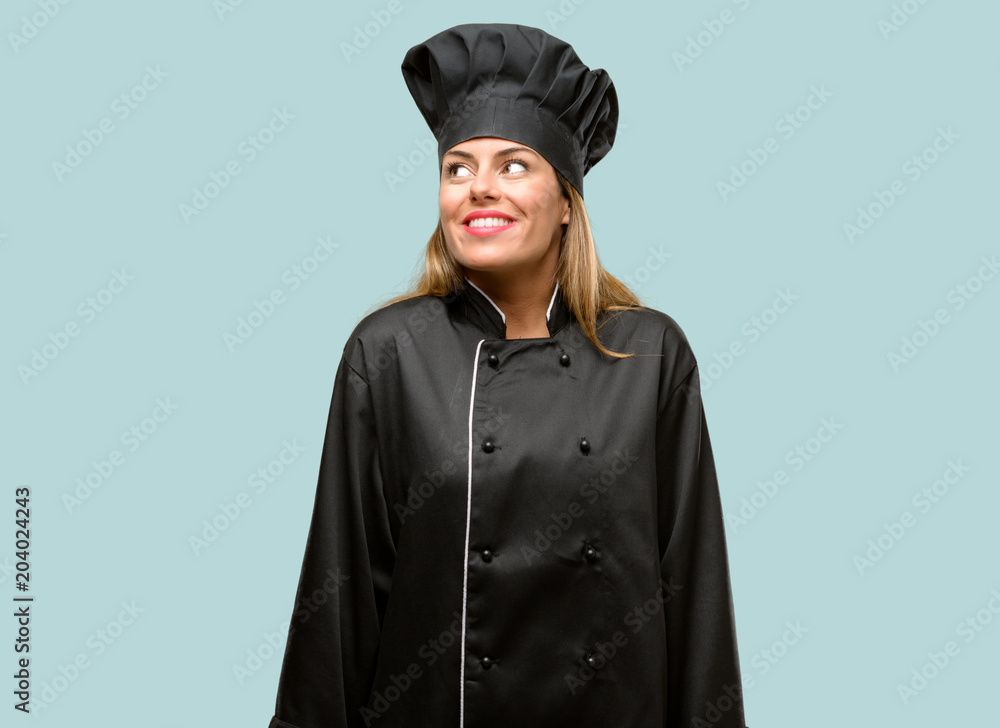 Young cook woman thinking and looking up expressing doubt and wonder Young cook woman thinking and looking up expressing doubt and wonder