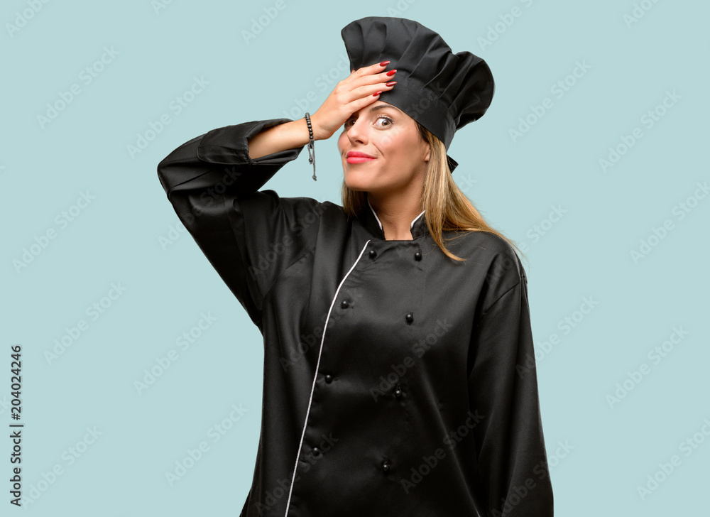 Young cook woman terrified and nervous expressing anxiety and panic gesture, overwhelmed Young cook woman terrified and nervous expressing anxiety and panic gesture, overwhelmed