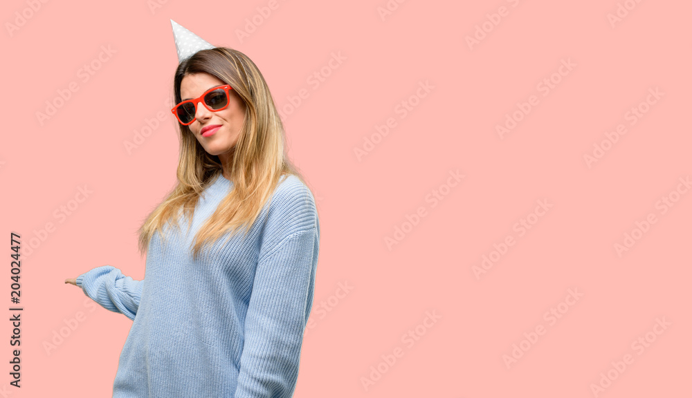 Young woman celebrates birthday confident and happy with a big natural smile inviting to enter