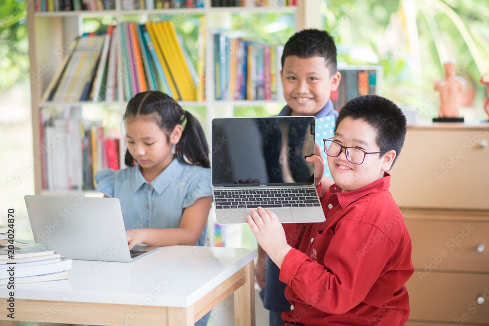 Students boy and girl in the library read books and ebook for education Students boy and girl in the library read books and ebook for education