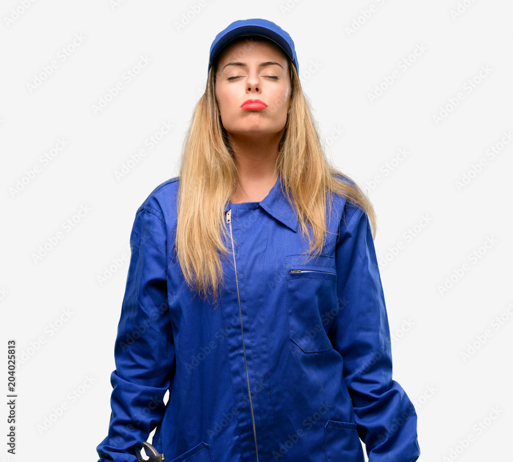 Young plumber woman with sleepy expression, being overworked and tired Young plumber woman with sleepy expression, being overworked and tired