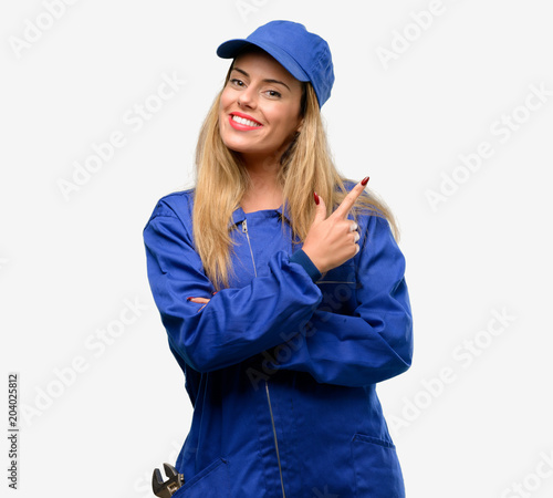 Young plumber woman pointing away side with finger