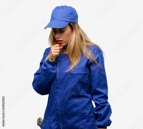 Young plumber woman sick and coughing, suffering asthma or bronchitis, medicine concept