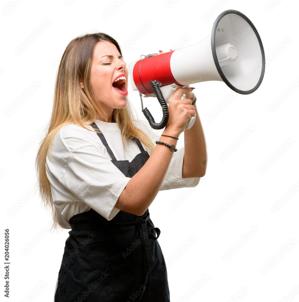 Shop owner woman wearing apron communicates shouting loud holding a megaphone, expressing success and positive concept, idea for marketing or sales Shop owner woman wearing apron communicates shouting loud holding a megaphone, expressing success and positive concept, idea for marketing or sales