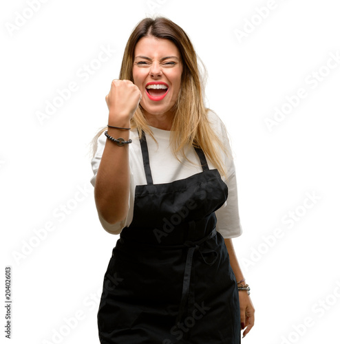 Shop owner woman wearing apron irritated and angry expressing negative emotion, annoyed with someone