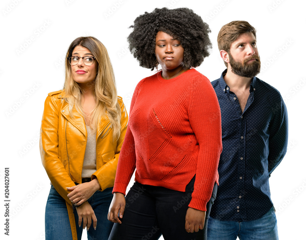 Group of three young men and women doubt expression, confuse and wonder concept, uncertain future Group of three young men and women doubt expression, confuse and wonder concept, uncertain future