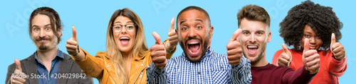 Foto Group of mixed people, women and men stand happy and positive with thumbs up app