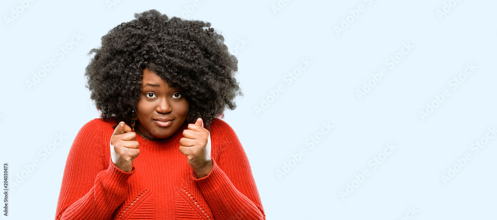 Beautiful african woman happy and surprised cheering expressing wow gesture, blue background Beautiful african woman happy and surprised cheering expressing wow gesture, blue background
