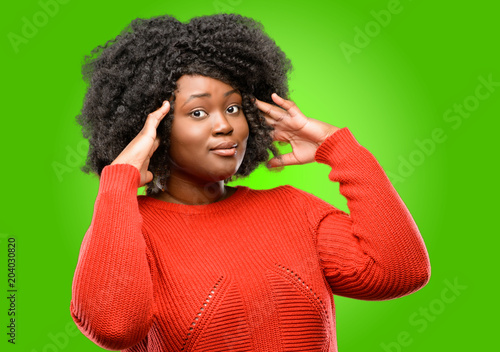 Beautiful african woman happy and surprised cheering expressing wow gesture