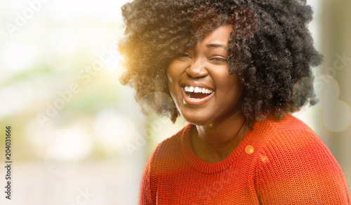 Beautiful african woman confident and happy with a big natural smile laughing, outdoor © Krakenimages.com