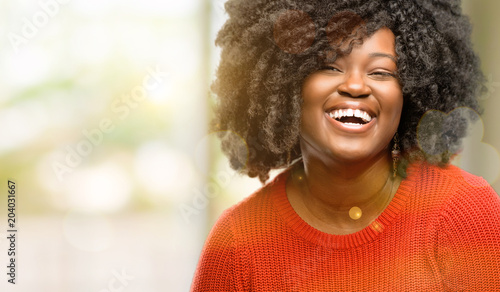 Beautiful african woman confident and happy with a big natural smile laughing, outdoor photo