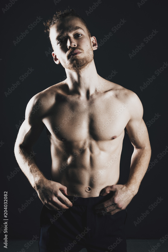 Fototapeta premium Young ginger topless man studio portrait