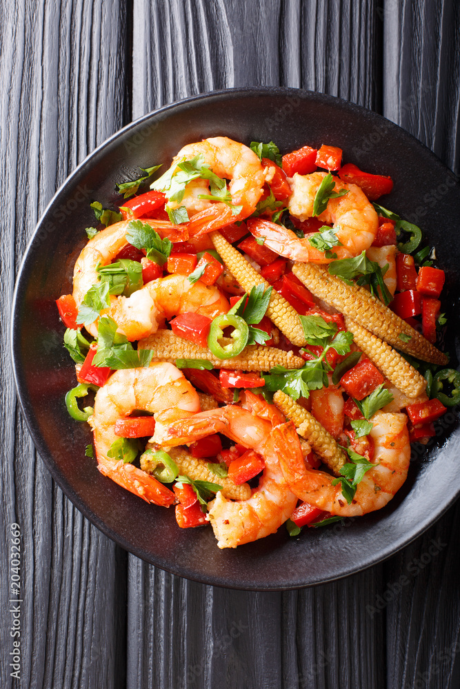 Mexican delicious prawns with pepper, garlic, corn cob and herbs close-up. Vertical top view