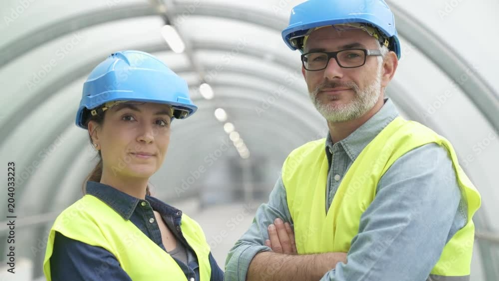 Industrial workers standing with security helmet on Industrial workers standing with security helmet on