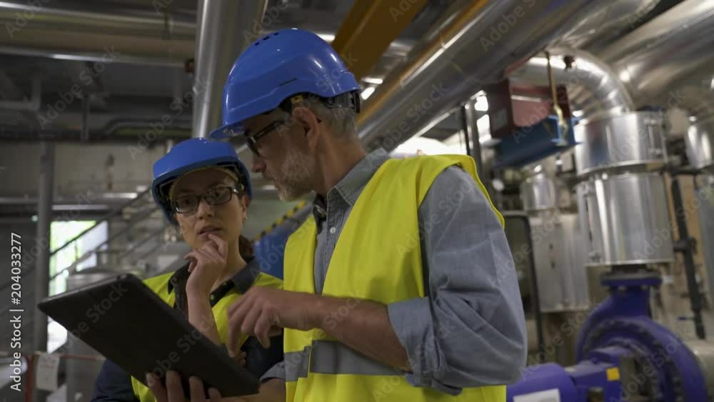 Industrial engineers working in recycling plant Industrial engineers working in recycling plant