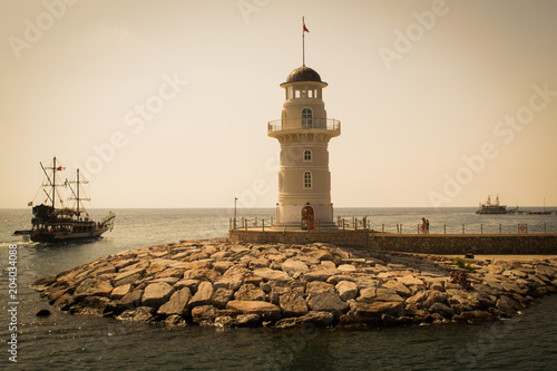 Lighthouse in Alanya, Turkey. Ships are walking along the Mediterranean Sea near the Lighthouse 