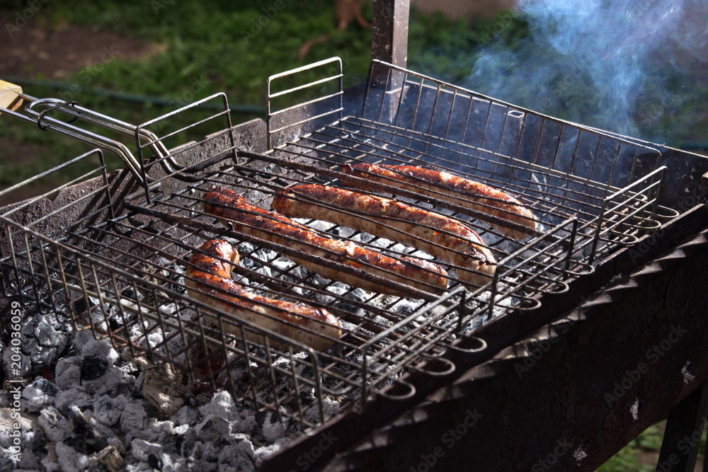 delicious grilled sausages, grilled meat, barbecue outdoors. delicious grilled sausages, grilled meat, barbecue outdoors.
