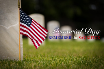 Small American flags and headstones at National cemetary- Memorial Day display - with copy