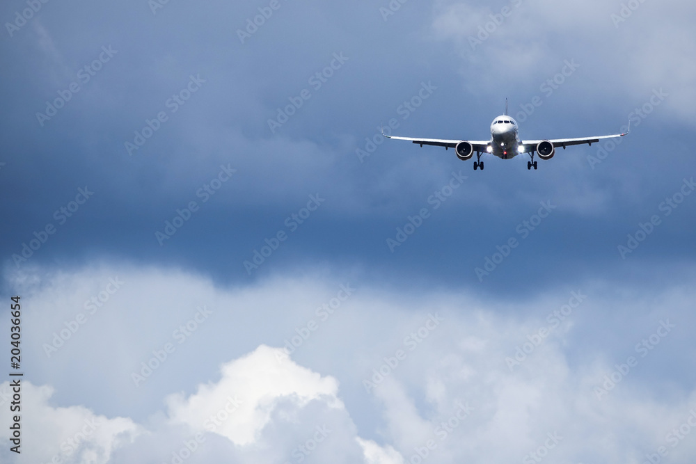 Jet aircraft / plane fly ahead in dark clouds and windy weather. Jet aircraft / plane. Blank copy space.