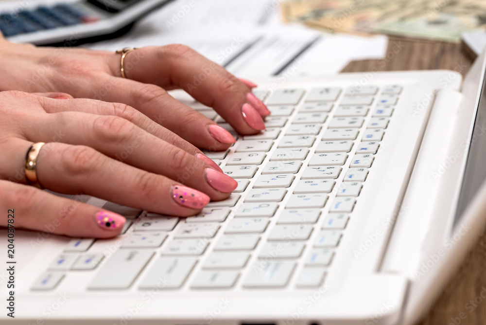 Woman typing on laptop, workplace, doing job Woman typing on laptop, workplace, doing job