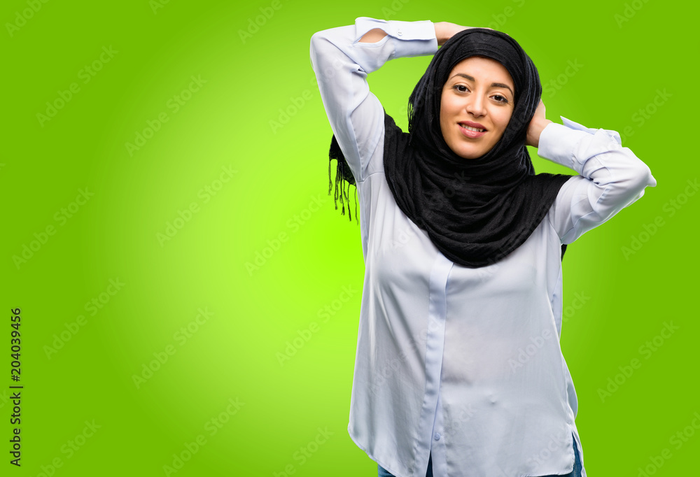 Young arab woman wearing hijab confident and happy with a big natural smile laughing Young arab woman wearing hijab confident and happy with a big natural smile laughing