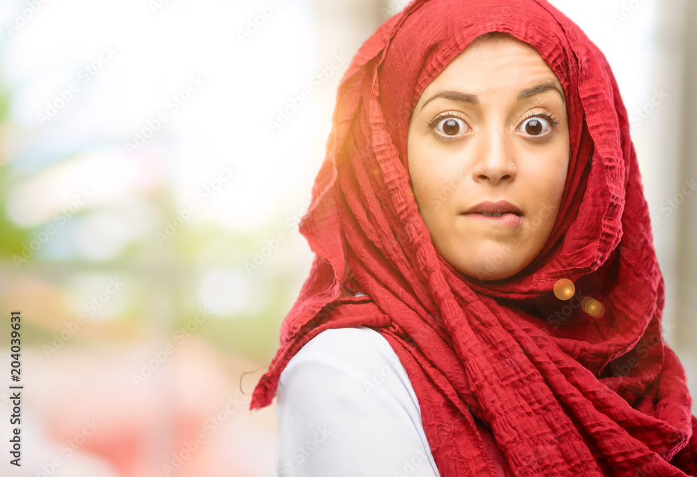 Young arab woman wearing hijab doubt expression, confuse and wonder concept, uncertain future Young arab woman wearing hijab doubt expression, confuse and wonder concept, uncertain future