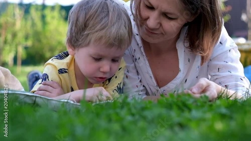 Little boy Playing with Tablet with his mother