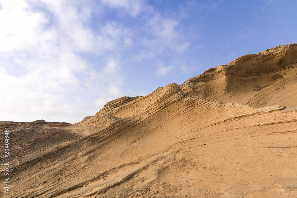 red layered rocks and blue sky