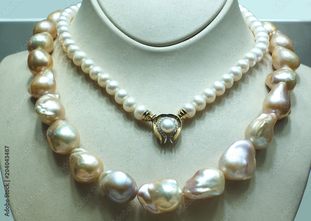 Precious pearl necklaces on a jewelry display. Precious pearl necklaces on a jewelry display.