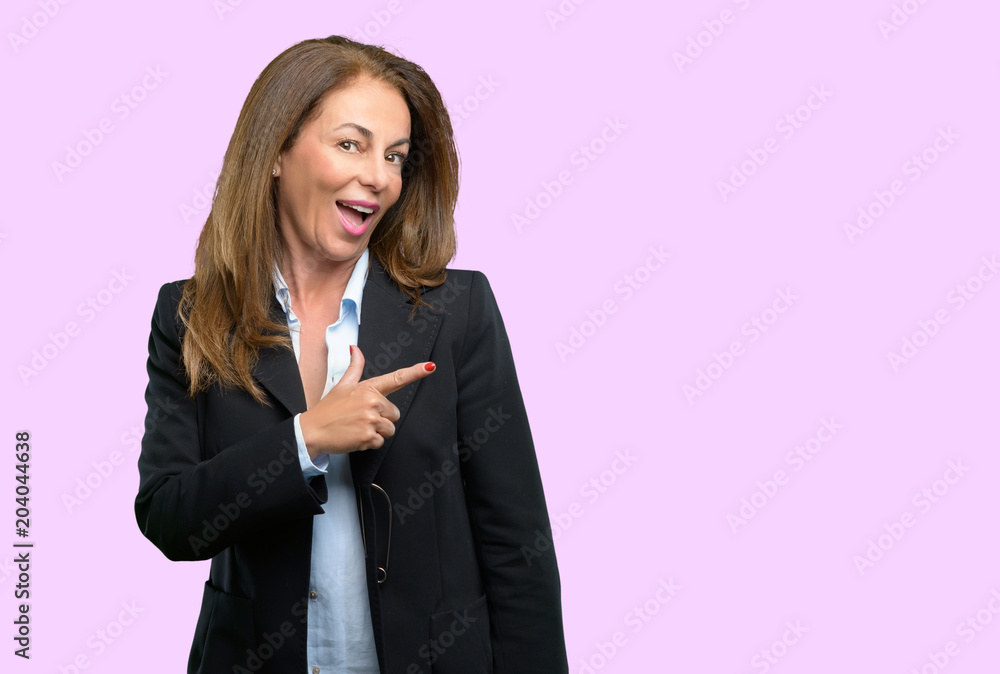 Middle age business woman pointing away side with finger Middle age business woman pointing away side with finger
