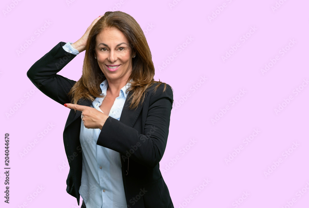 Middle age business woman pointing away side with his finger Middle age business woman pointing away side with his finger