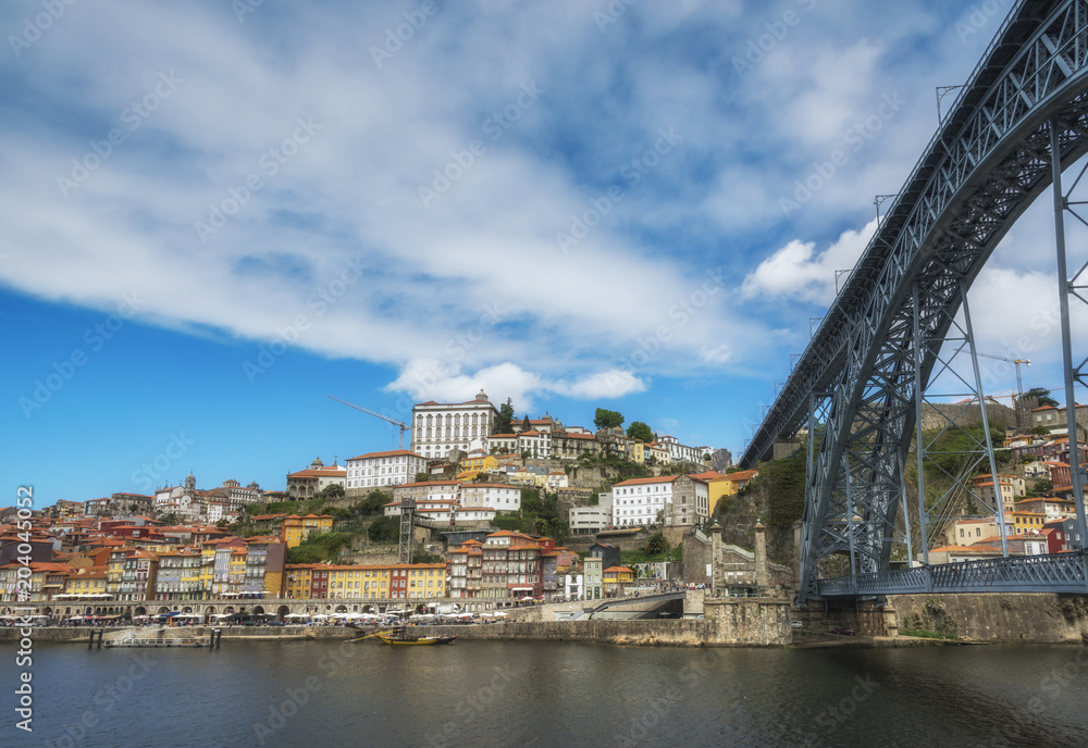 View of colorful old houses of Porto from under the Dom Luis Bridge. Douro River. Porto, Portugal.