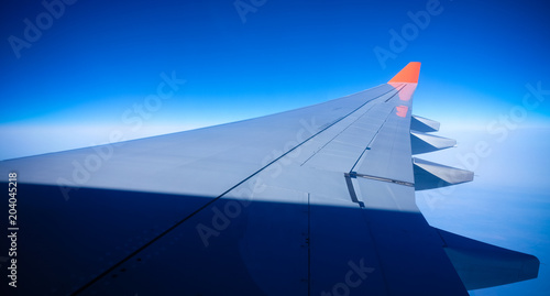 Close up Airplane window with airplane wing