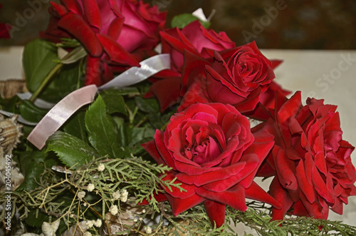 Bouquet of red roses with eucalyptus sprigs  seashells  satin ribbon    