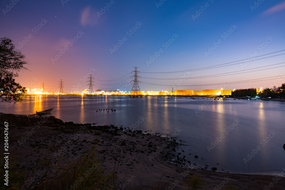 power plant light riverfront reflection at twilight- industrial landscape background