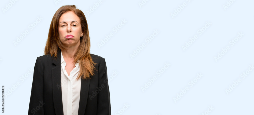 Middle age woman wearing jacket with sleepy expression, being overworked and tired isolated blue background Middle age woman wearing jacket with sleepy expression, being overworked and tired isolated blue background