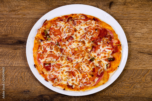 Pizza with sausages and tomato