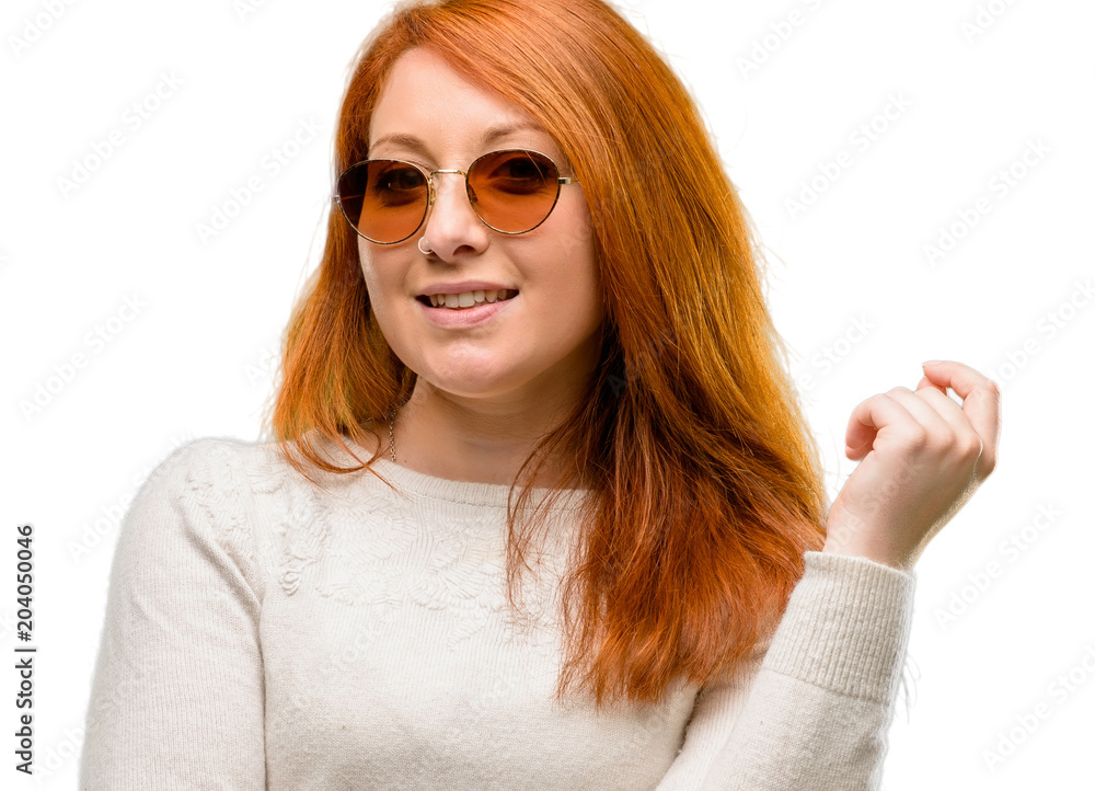 Beautiful young redhead woman confident and happy with a big natural smile laughing isolated over white background Beautiful young redhead woman confident and happy with a big natural smile laughing isolated over white background