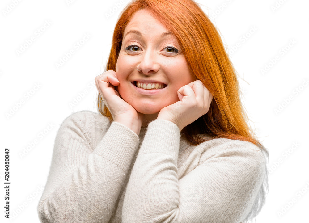 Beautiful young redhead woman happy and surprised cheering expressing wow gesture isolated over white background Beautiful young redhead woman happy and surprised cheering expressing wow gesture isolated over white background