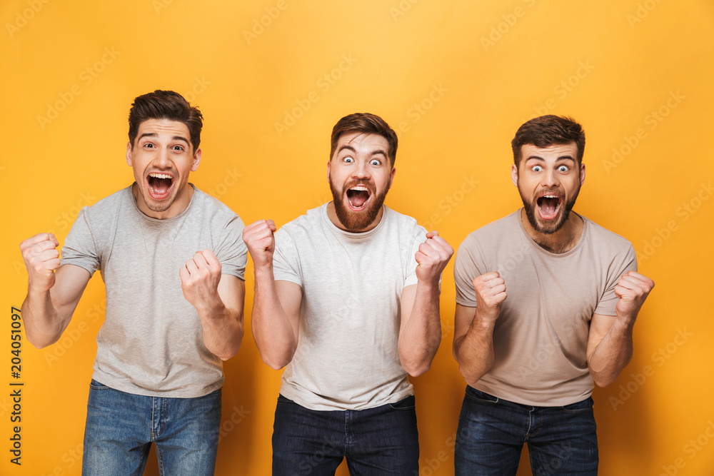 Three young happy men celebrating success together Three young happy men celebrating success together