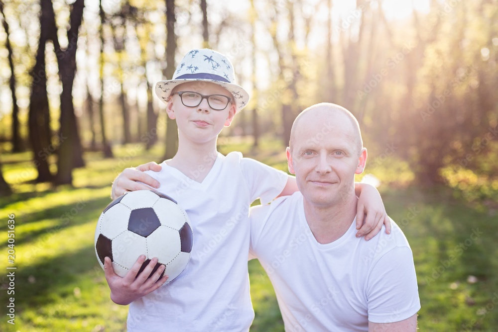 Obraz premium Happy father and son portrait in park