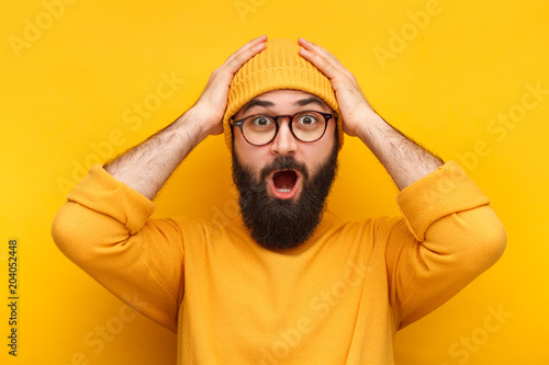 Tableau sur toile Bearded puzzled hipster in glasses