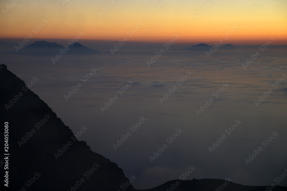 Spectacular sunset over the Aeolian Islands seen from the summit of Volcano Stromboli, Sicily, Italy